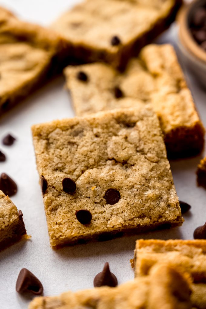 Chocolate chip cookie bars on a surface.