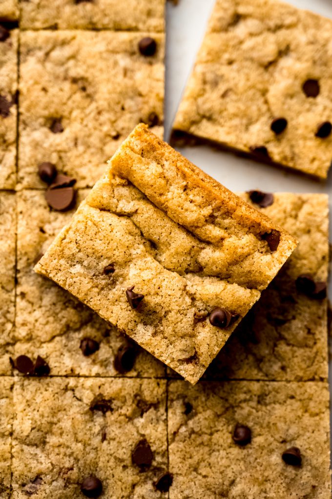 Aerial photo of chocolate chip cookie bars on a surface.