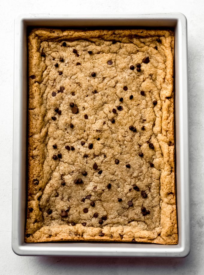 Aerial photo of chocolate chip cookie bars baked in a pan before slicing.