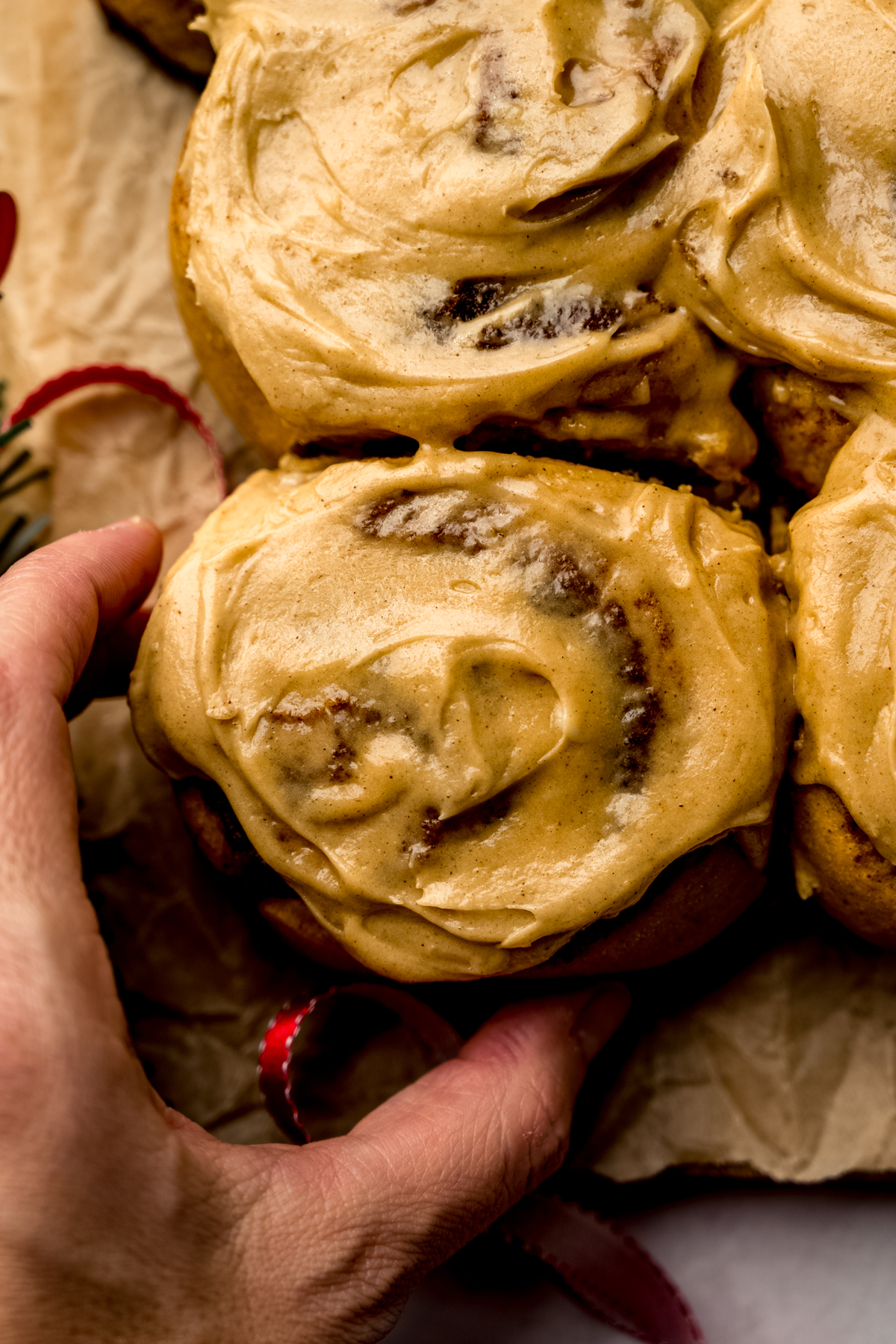 Aerial photo of someone grabbing a gingerbread cinnamon roll.