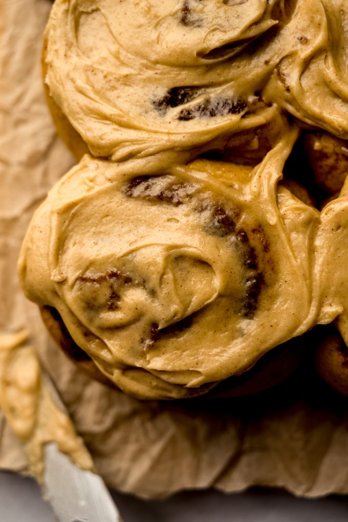 Aerial photo of gingerbread cinnamon rolls on parchment paper.