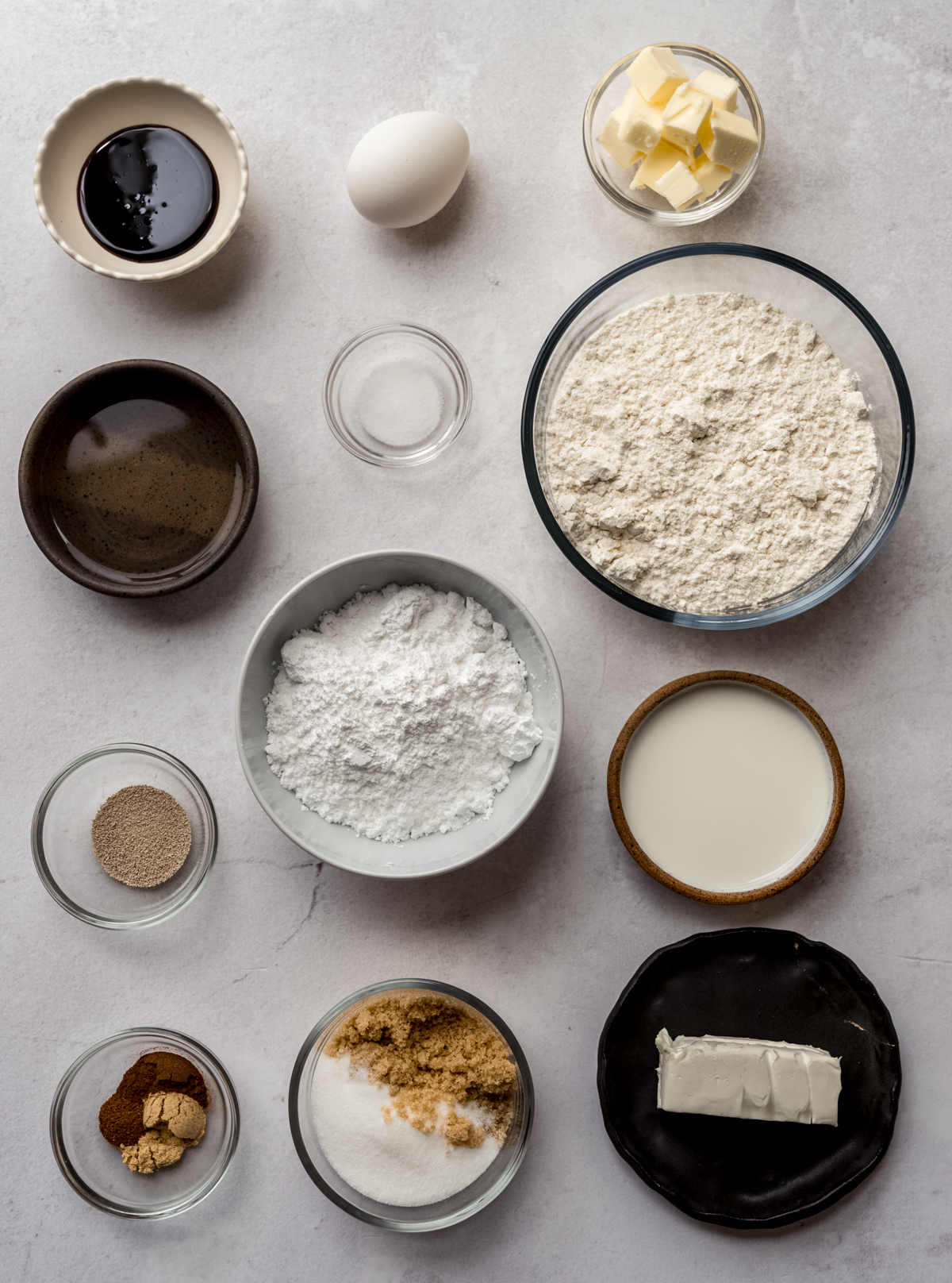 Aerial photo of the ingredients to make gingerbread cinnamon rolls on a surface.