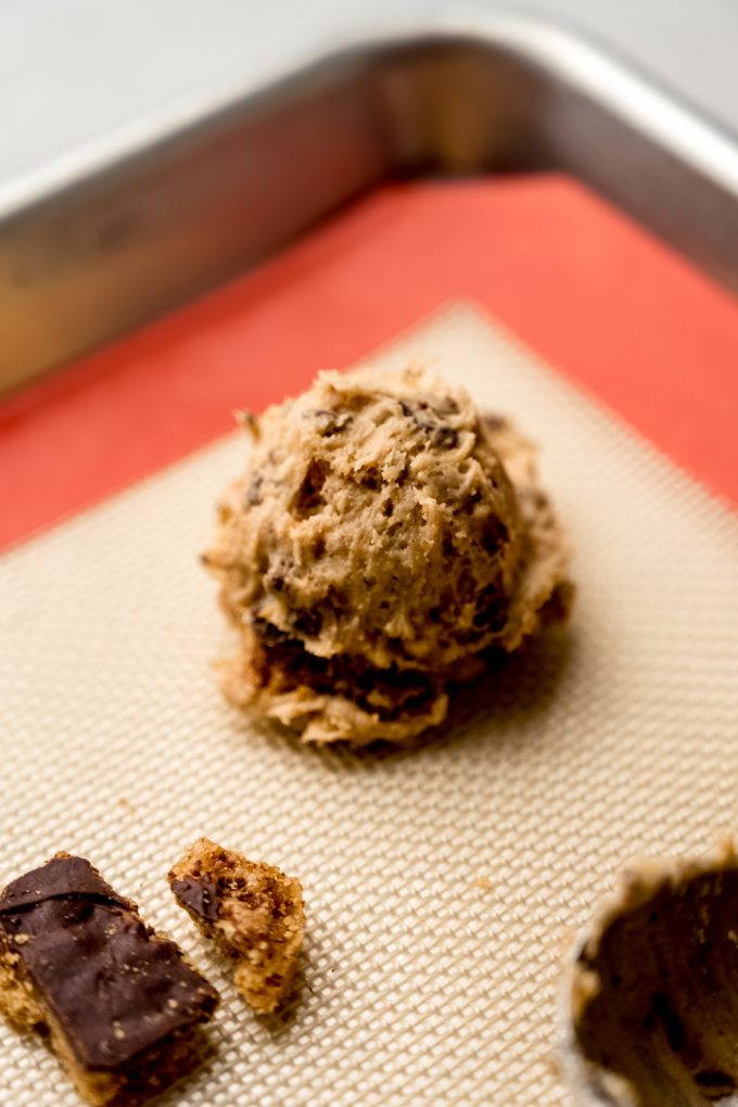 A ball of graham cracker toffee cookie dough on a baking sheet.