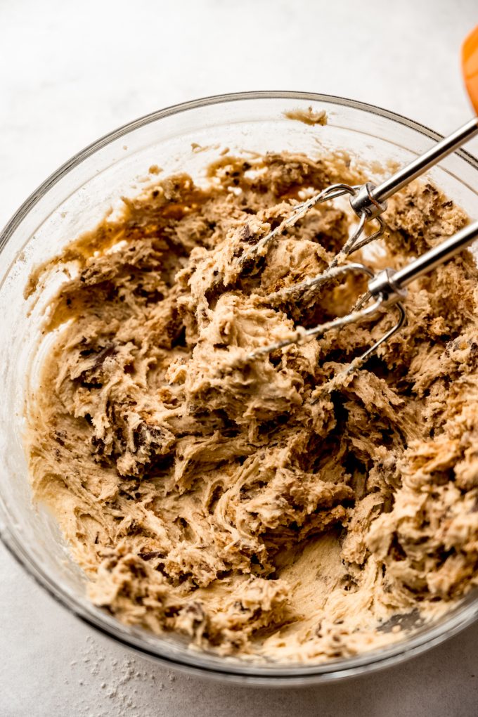 Graham cracker toffee cookie dough in a bowl with electric beaters.