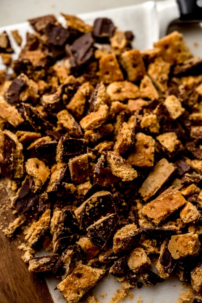 Chopped graham cracker toffee on a cutting board.