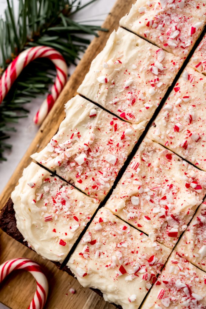 Aerial photo of peppermint bark cookie bars sliced into pieces on a cutting board.