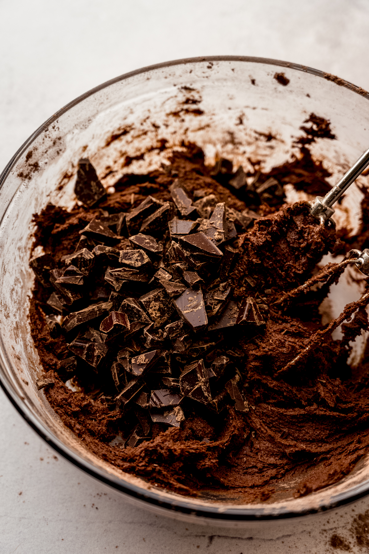 A bowl with chocolate chunk cookie dough in it.