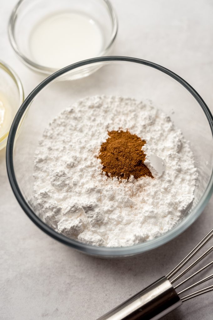 A bowl full of the ingredients for cinnamon sugar glaze.