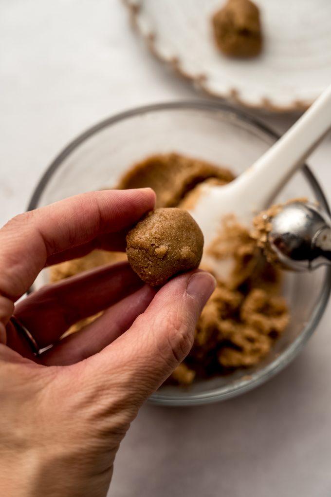 Someone is holding a ball of brown sugar filling for Pop Tart cookies.