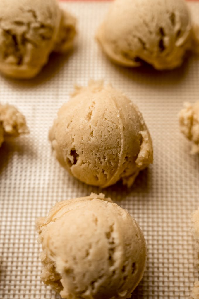 Cookie dough balls on a baking sheet.