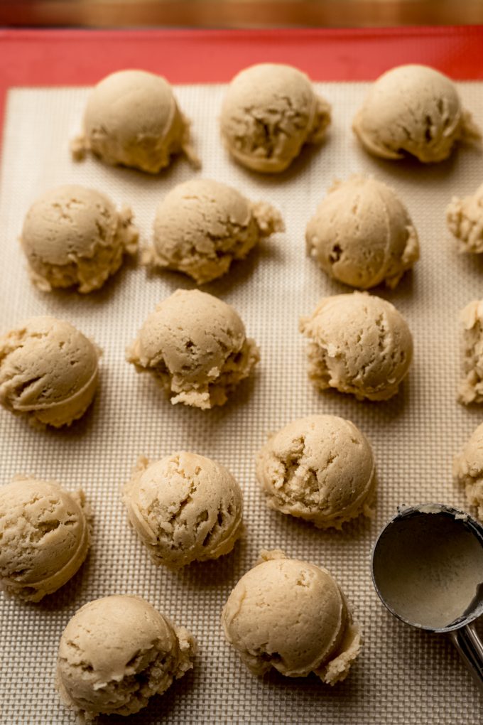 Cookie dough balls on a baking sheet.