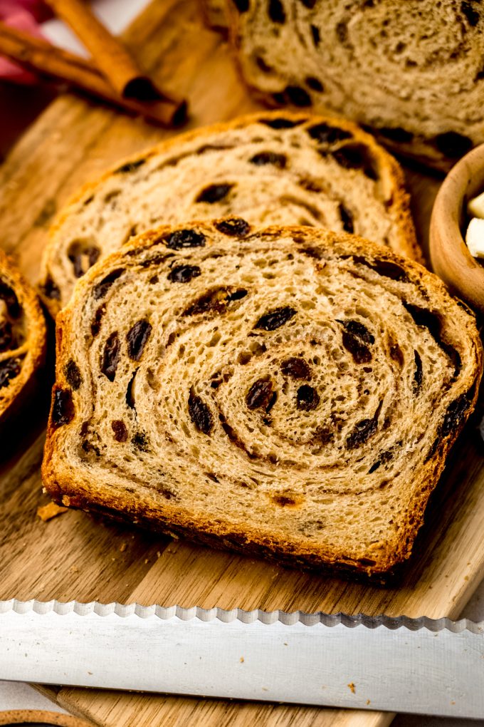 Sliced cinnamon raisin bread on a surface.
