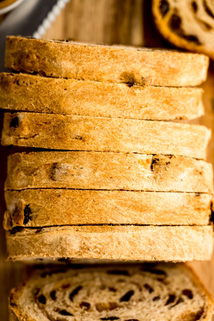 Sliced cinnamon raisin bread on a surface.