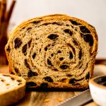 Sliced cinnamon raisin bread on a surface.