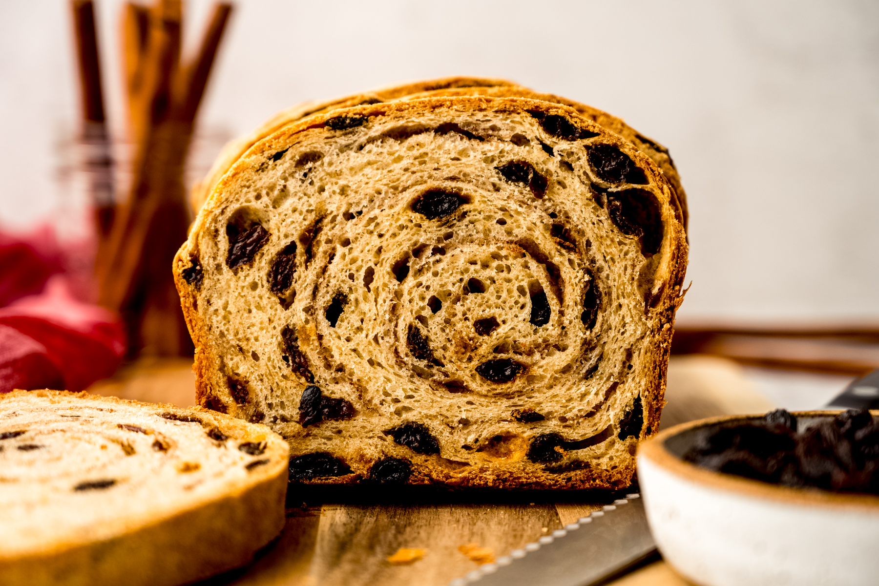 Sliced cinnamon raisin bread on a surface.