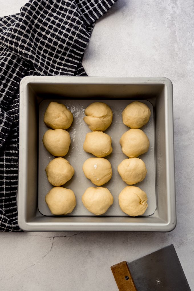 Aerial photo of slider dough balls in a baking pan before they have risen.