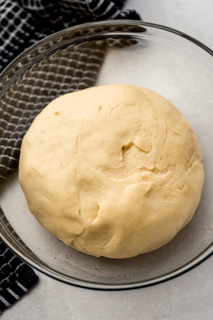 Mini slider roll dough in a bowl after it has risen.