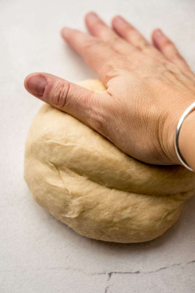 Someone is kneading a ball of yeast dough.