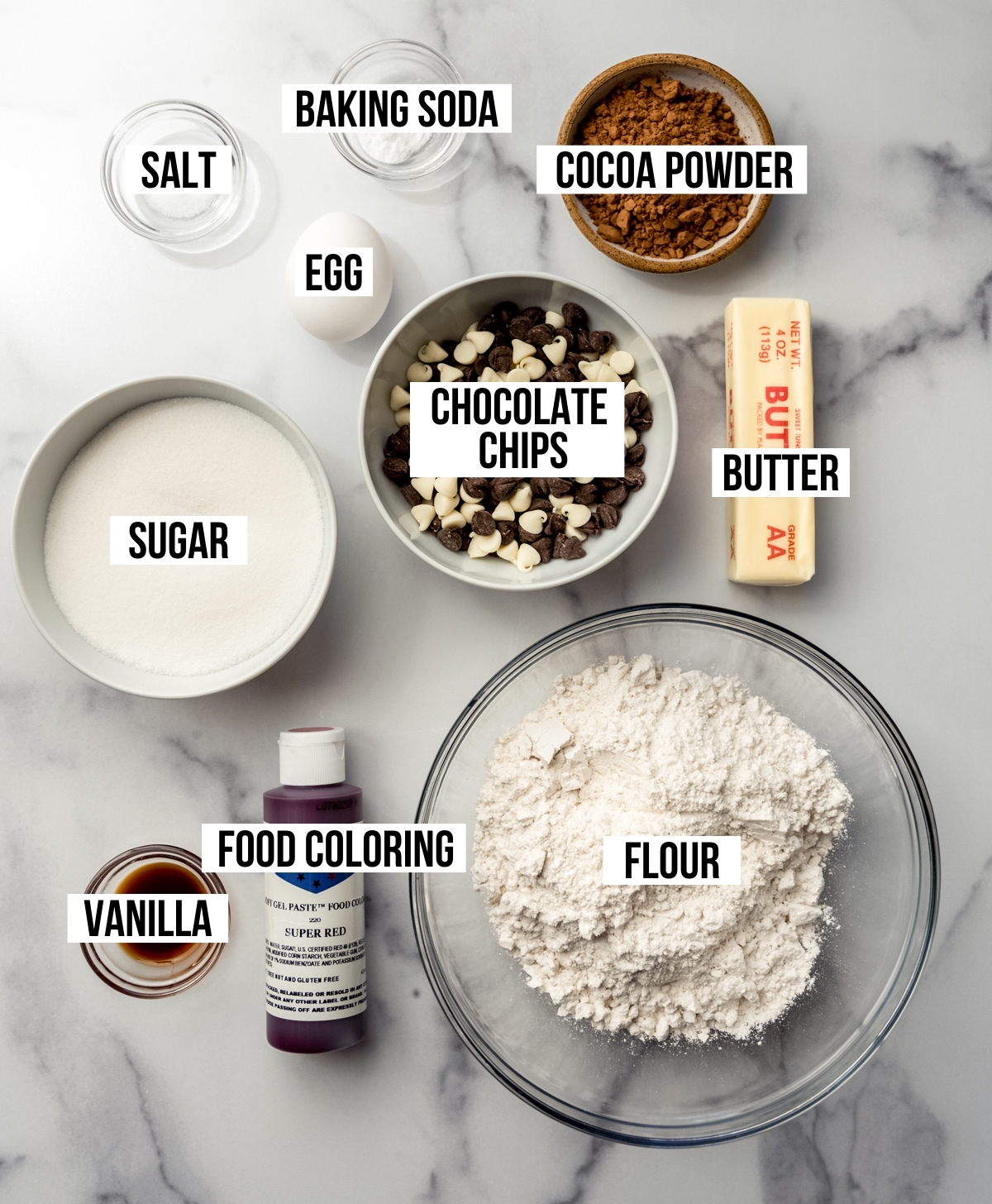 Aerial photo of the ingredients to make red velvet chocolate chip cookies with text overlay labeling each ingredient.