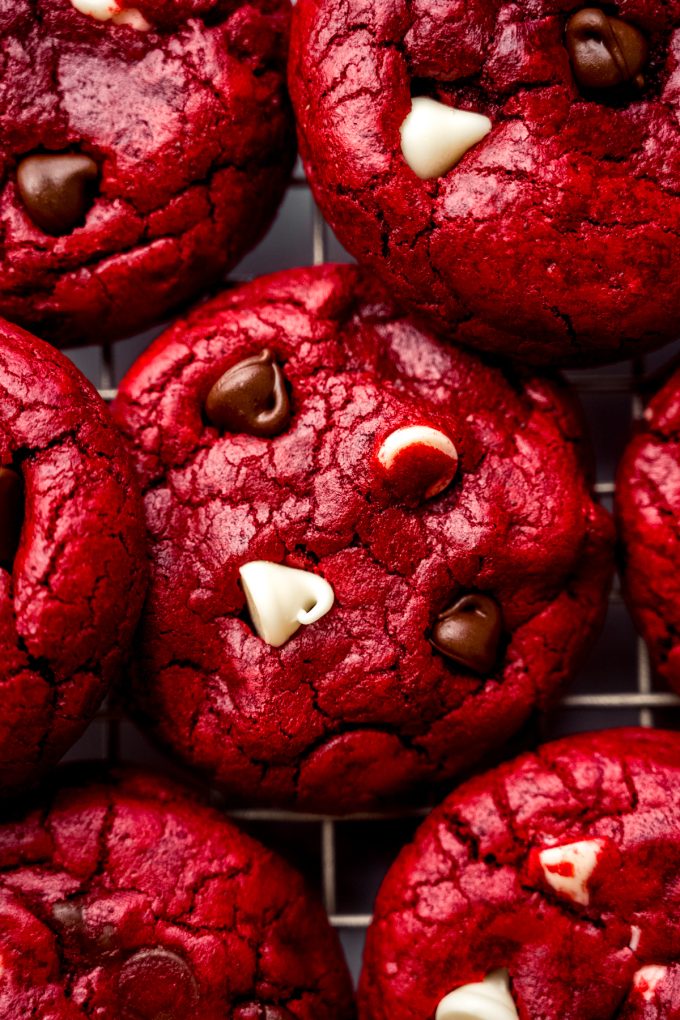 Red velvet chocolate chip cookies on a cooling rack.