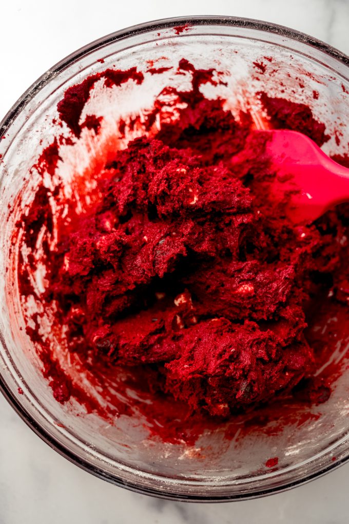Red velvet chocolate chip cookie dough in a bowl.