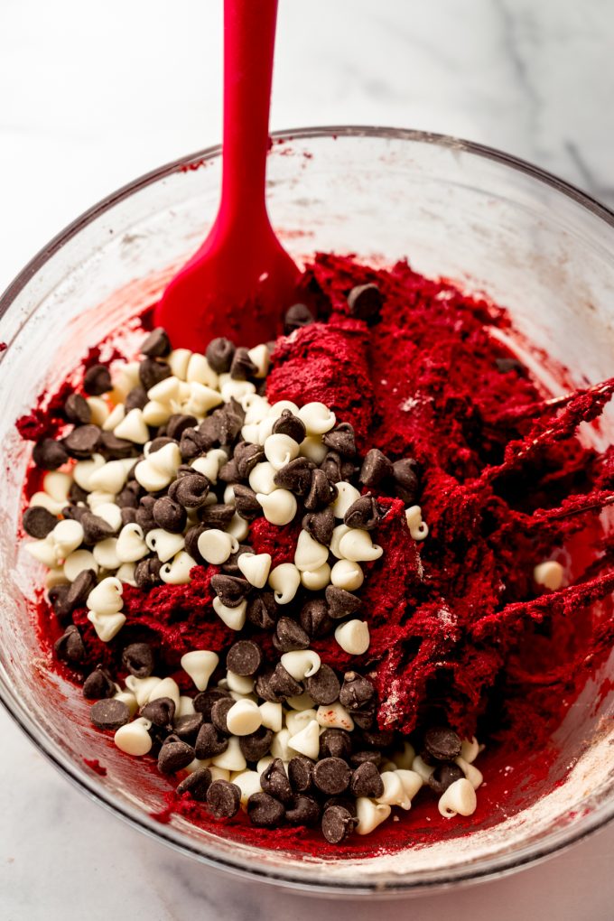 Red velvet chocolate chip cookie dough in a bowl.