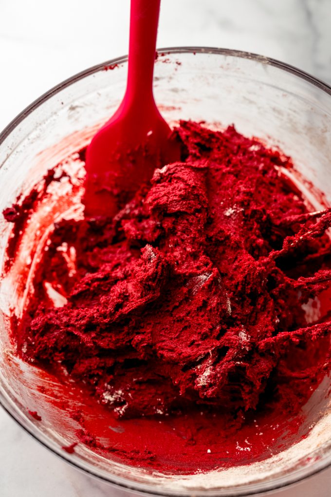 Red velvet chocolate chip cookie dough in a bowl.