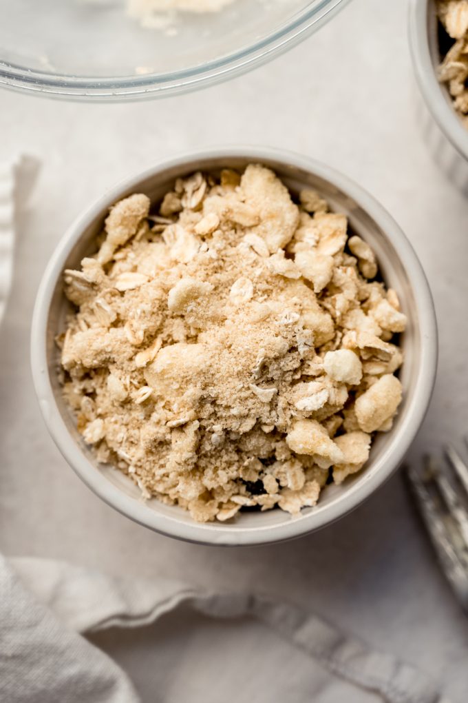 Aerial photo of a ramekin of blueberry crisp before baking.