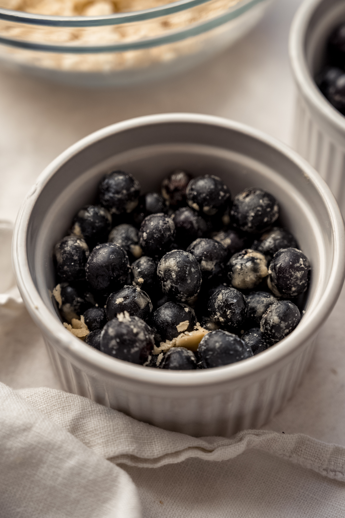 A ramekin with blueberries in it.