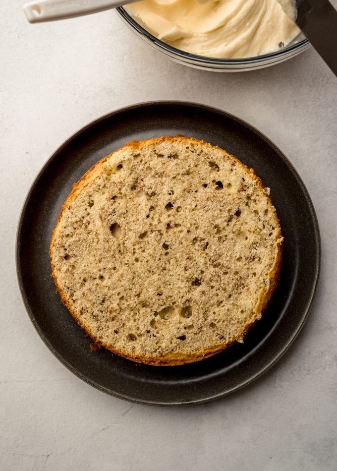 A layer of butter pecan cake on a plate.
