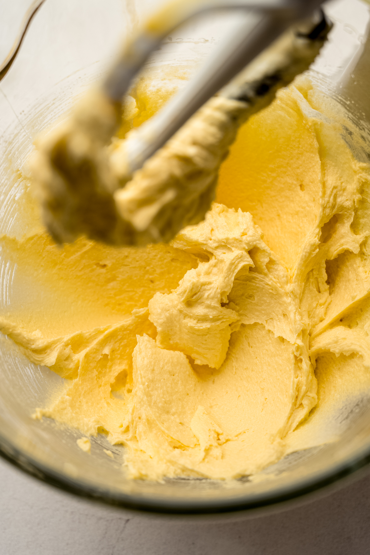 The batter for butter pecan cake in the bowl of a stand mixer.