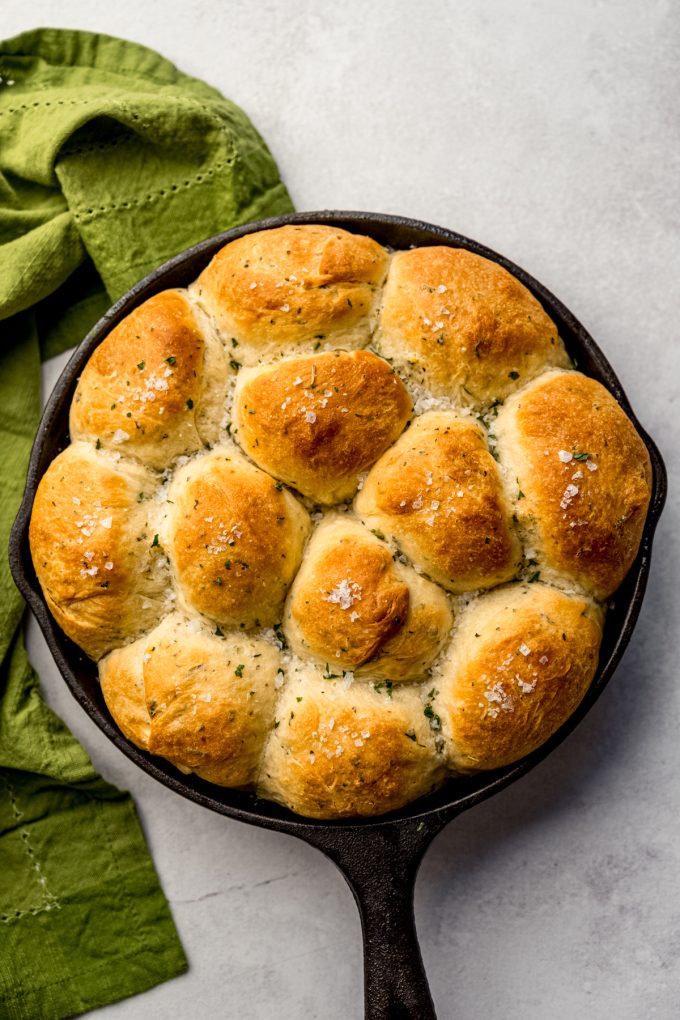 Aerial photo of a skillet with herbed rolls in it.