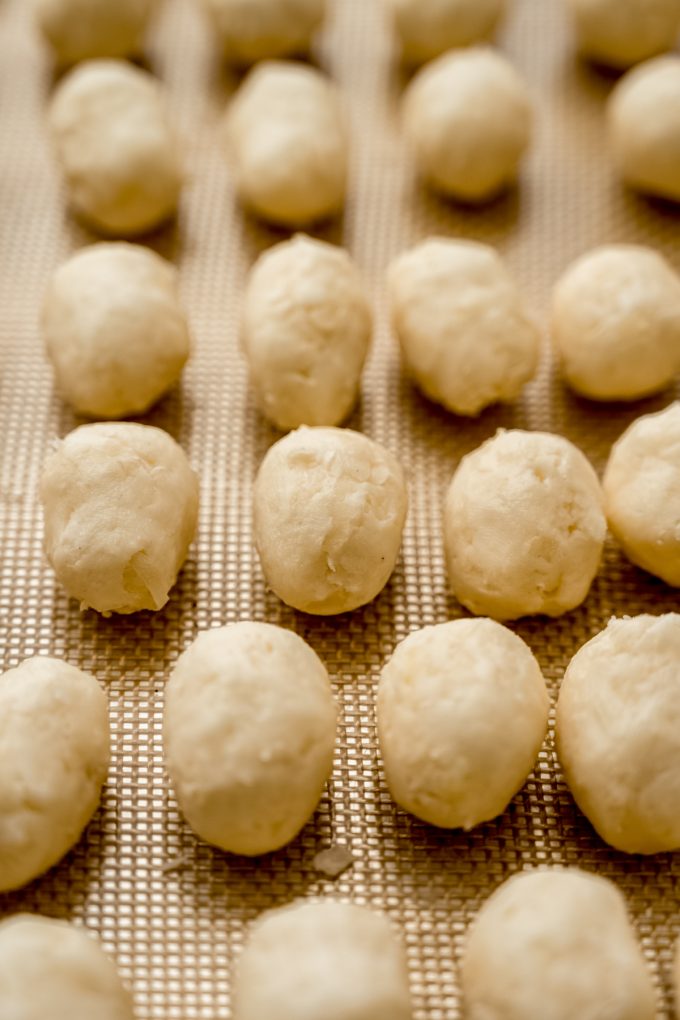 Irish potato candy on a baking sheet before getting rolled in cinnamon.