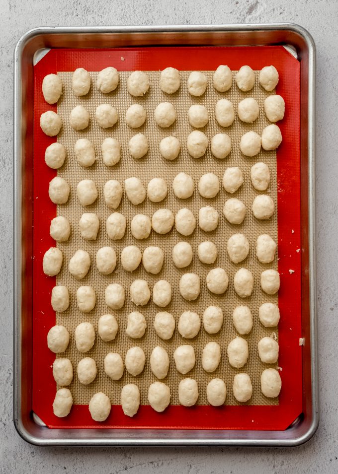Irish potato candy on a baking sheet before getting rolled in cinnamon.