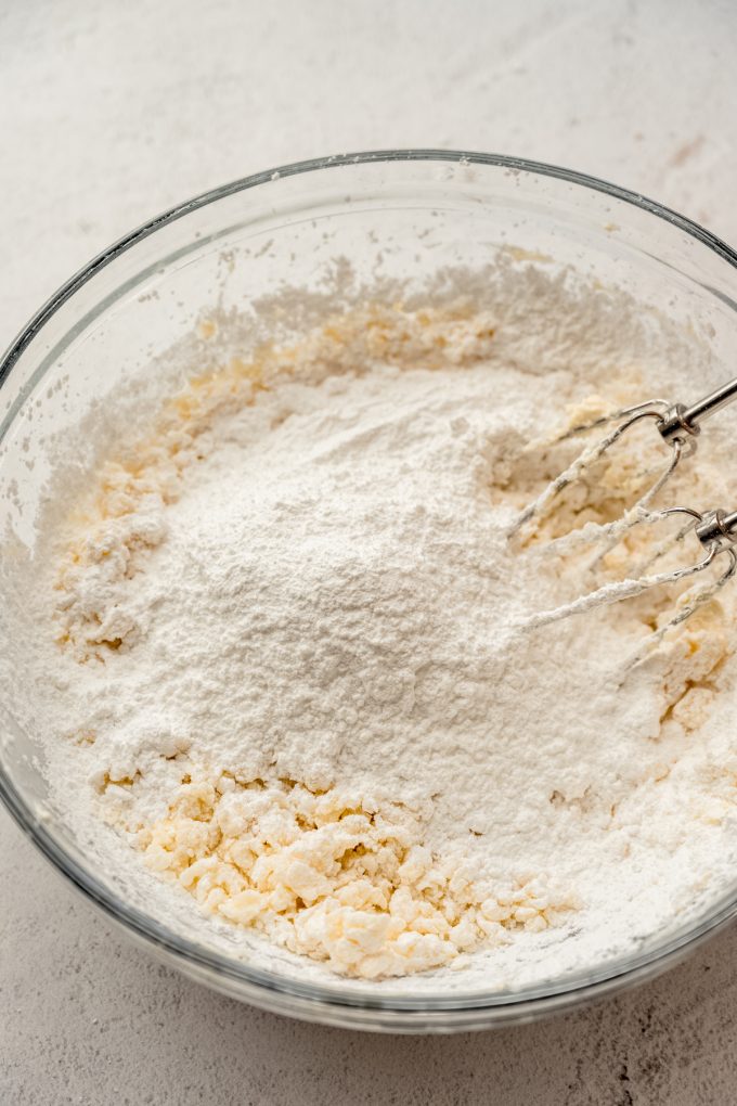 A bowl of the filling for Irish potato candy with a electric beaters it in.