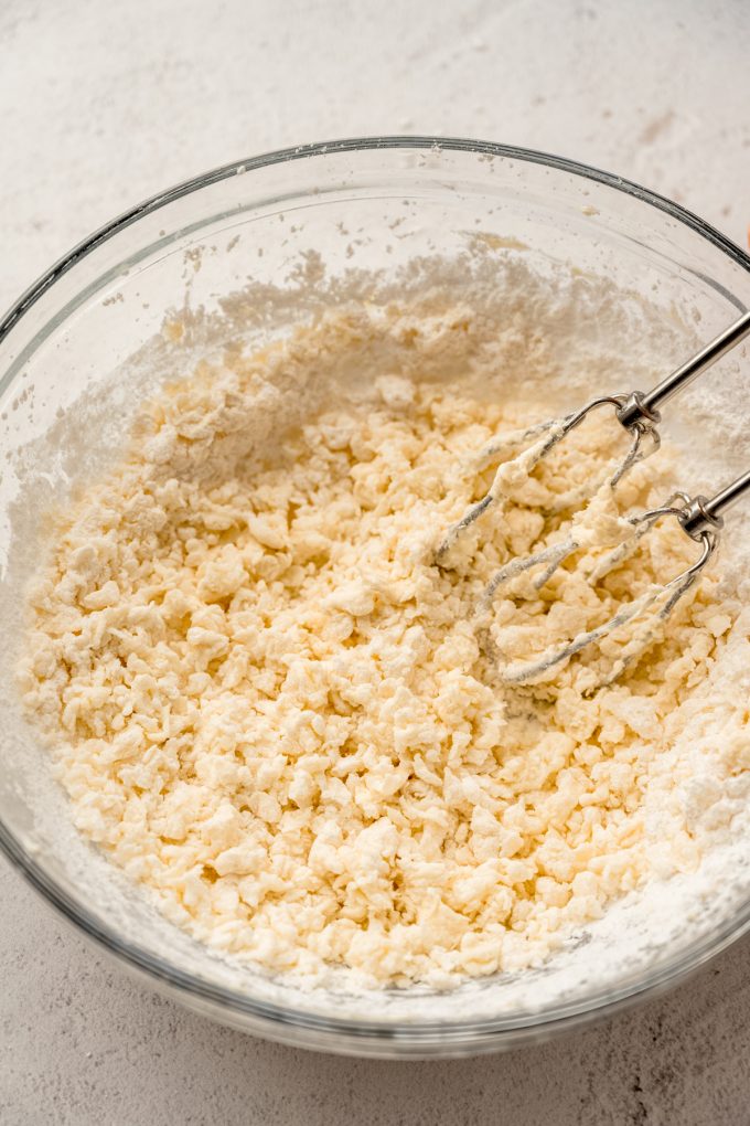 A bowl of the filling for Irish potato candy with a electric beaters it in.