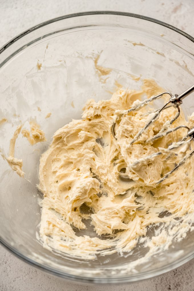 A bowl of the filling for Irish potato candy with a electric beaters it in.