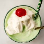 Aerial photo of a Shamrock shake that has some bites taken out of it.