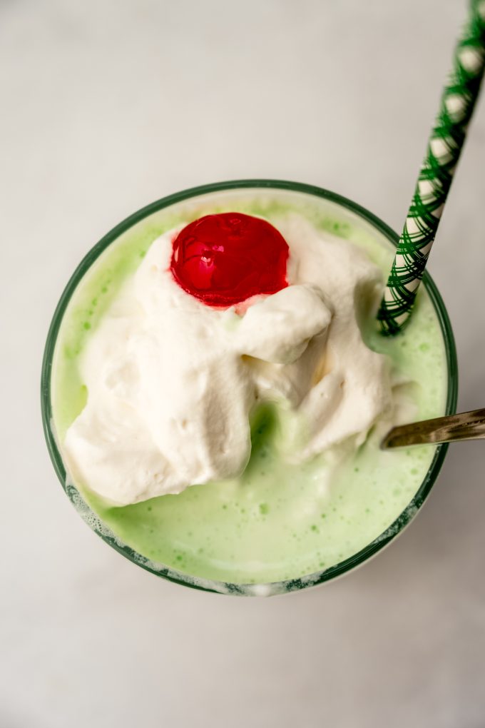 Aerial photo of a Shamrock shake that has some bites taken out of it.