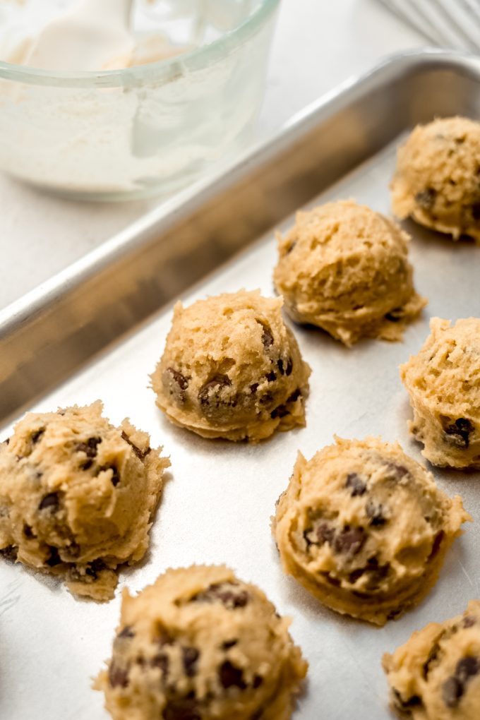 Sourdough discard chocolate chip cookie dough balls on a baking sheet.