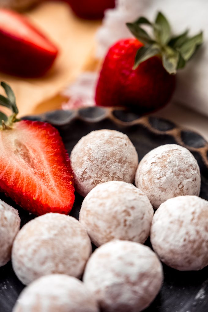 A plate of strawberry truffles.
