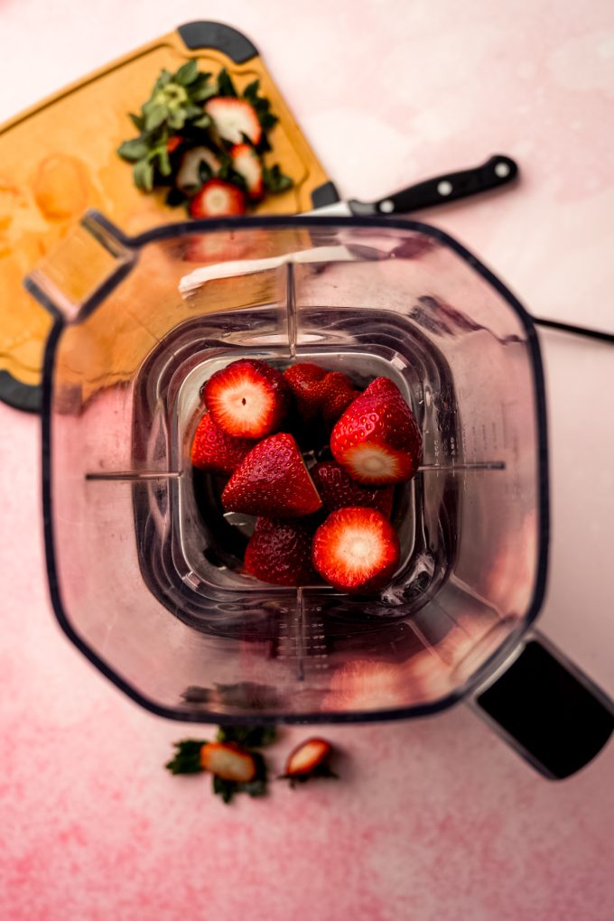 Aerial photo of a blender with strawberries in it.