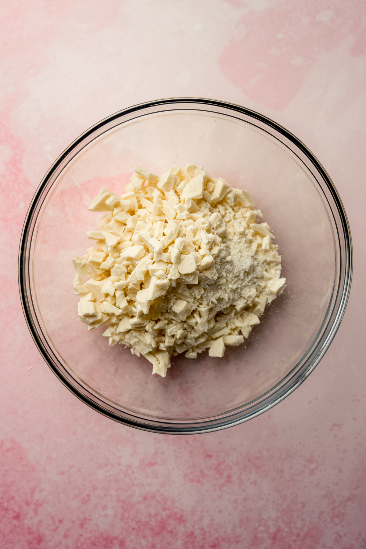 Aerial photo of a bowl of chopped white chocolate.
