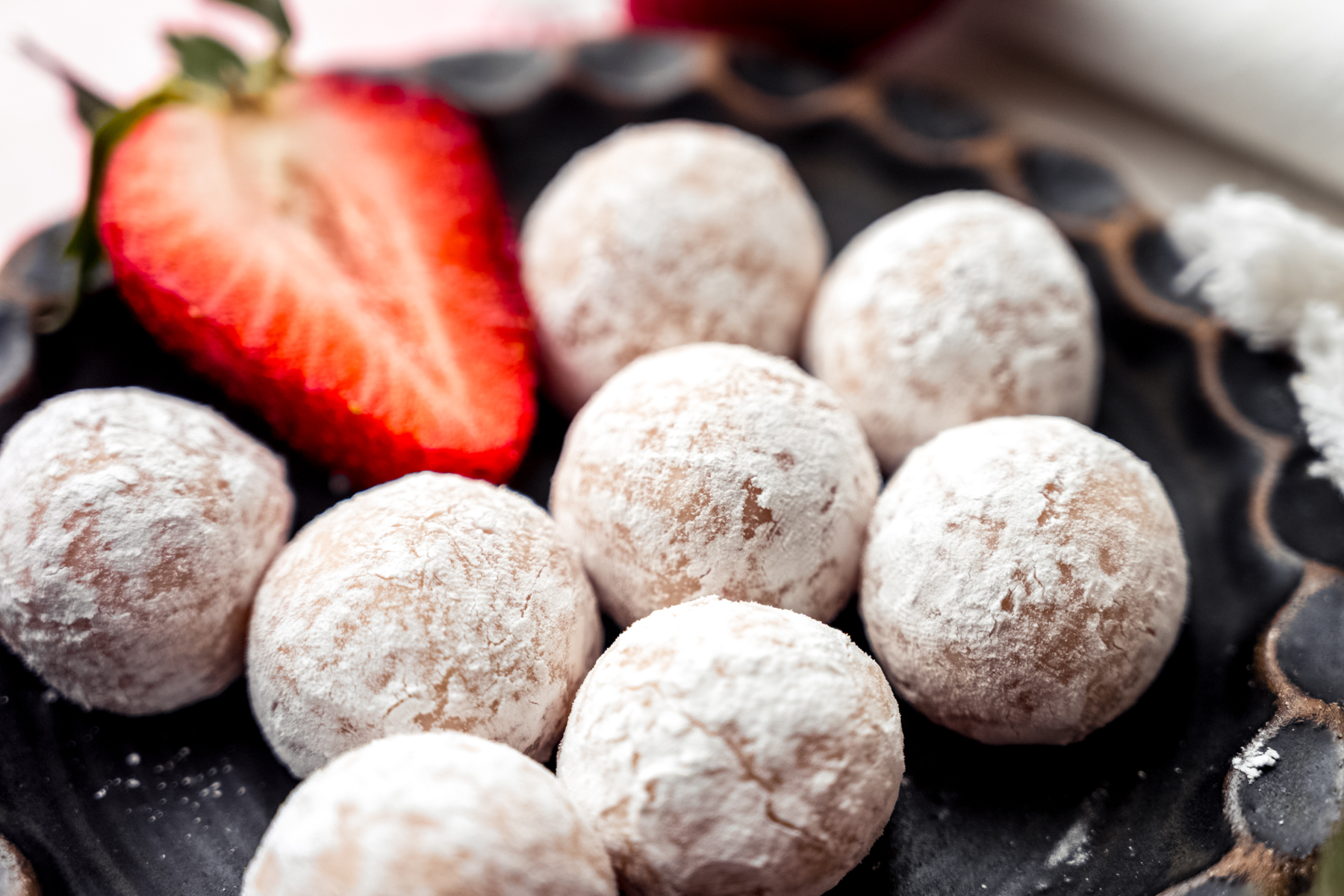 A plate of strawberry truffles.