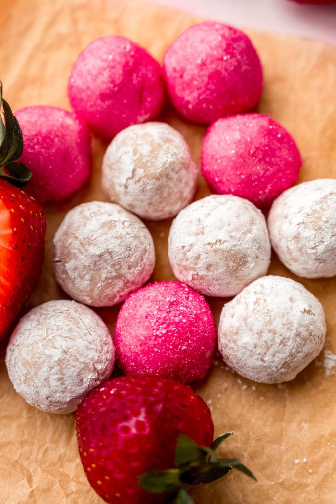 Strawberry truffles on a surface.