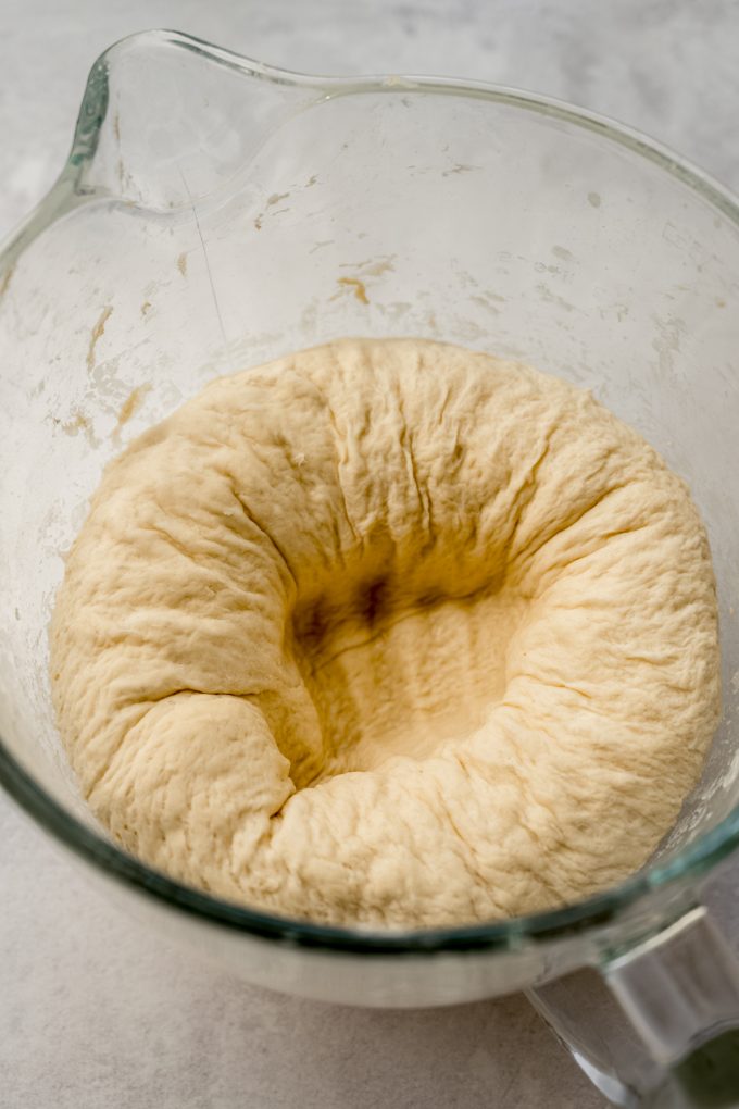 A bowl of yeast dough that has been punched down.