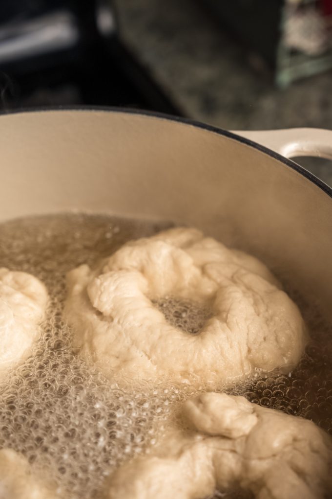 Rings of bagels in a water bath.