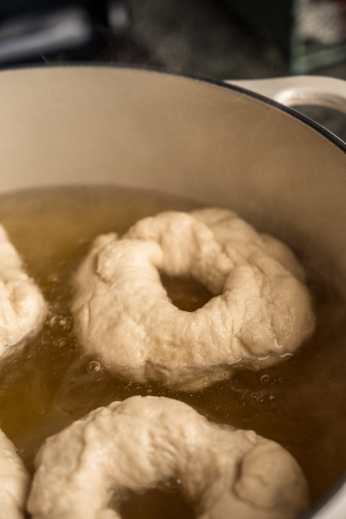 Rings of bagels in a water bath.