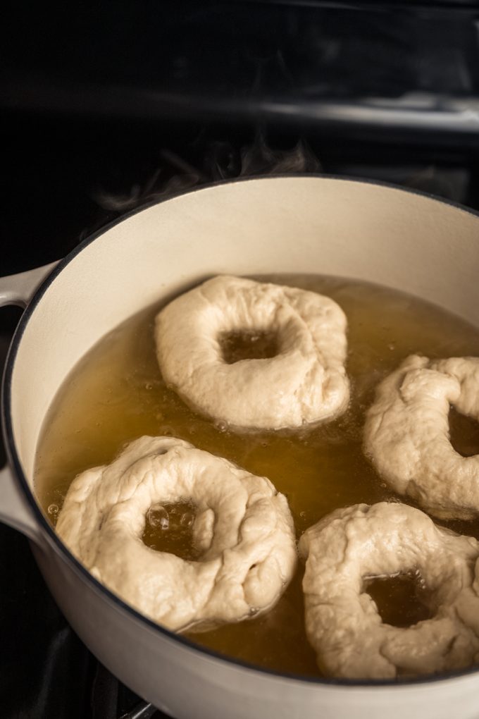 Rings of bagels in a water bath.
