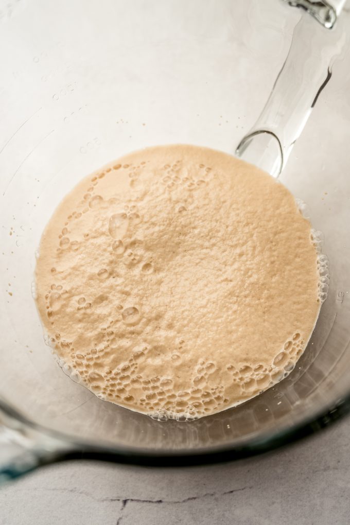 Proofed yeast and water in the bowl of a stand mixer.